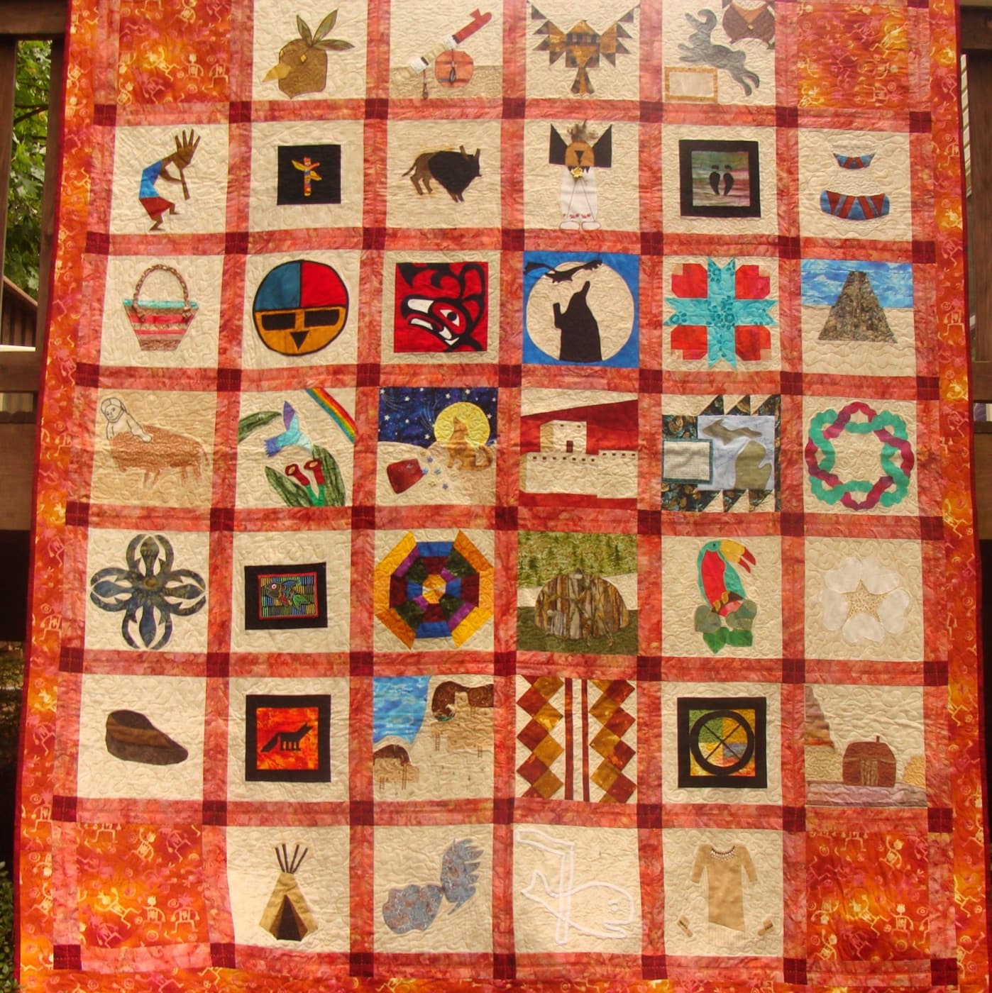 Finished sampler quilt from the NF21 Native American Heritage swap — appliqué blocks from quilters across the country